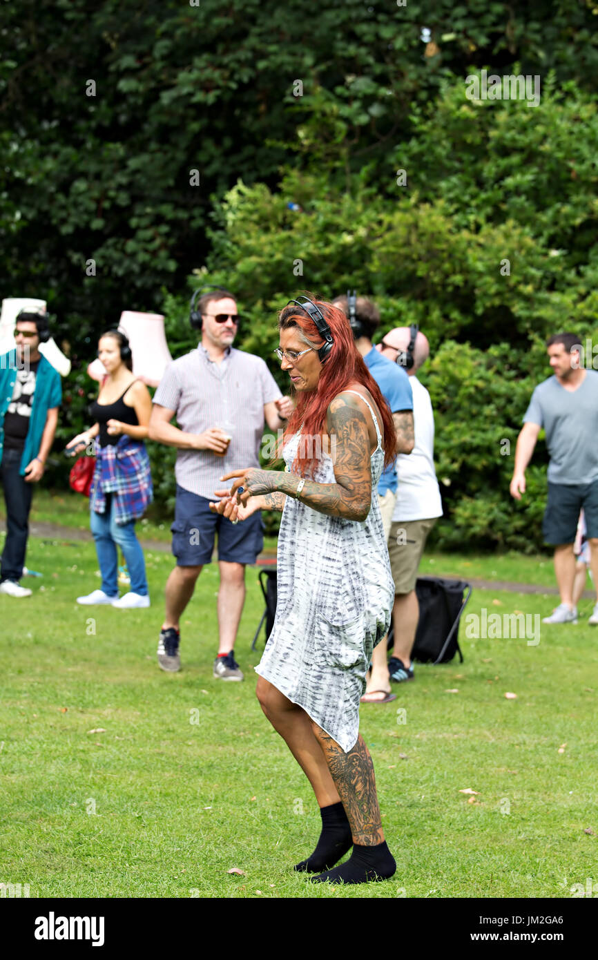 Heavily tattooed woman dancing at the International Music Festival in Sefton Park Liverpool in July 2017 Stock Photo