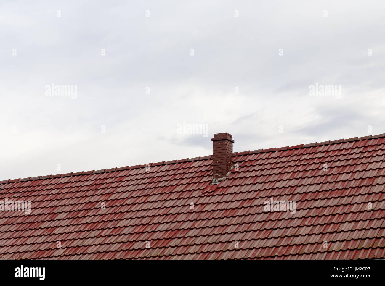 House roof with red tile and brick chimney Stock Photo - Alamy