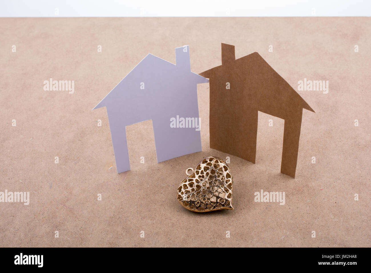 Heart shaped icon and paper houses on a brown background Stock Photo ...