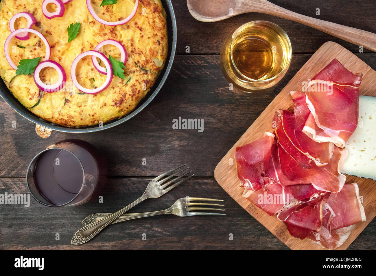 Spanish tortilla in tortillera, with wine, jamon, and cheese Stock