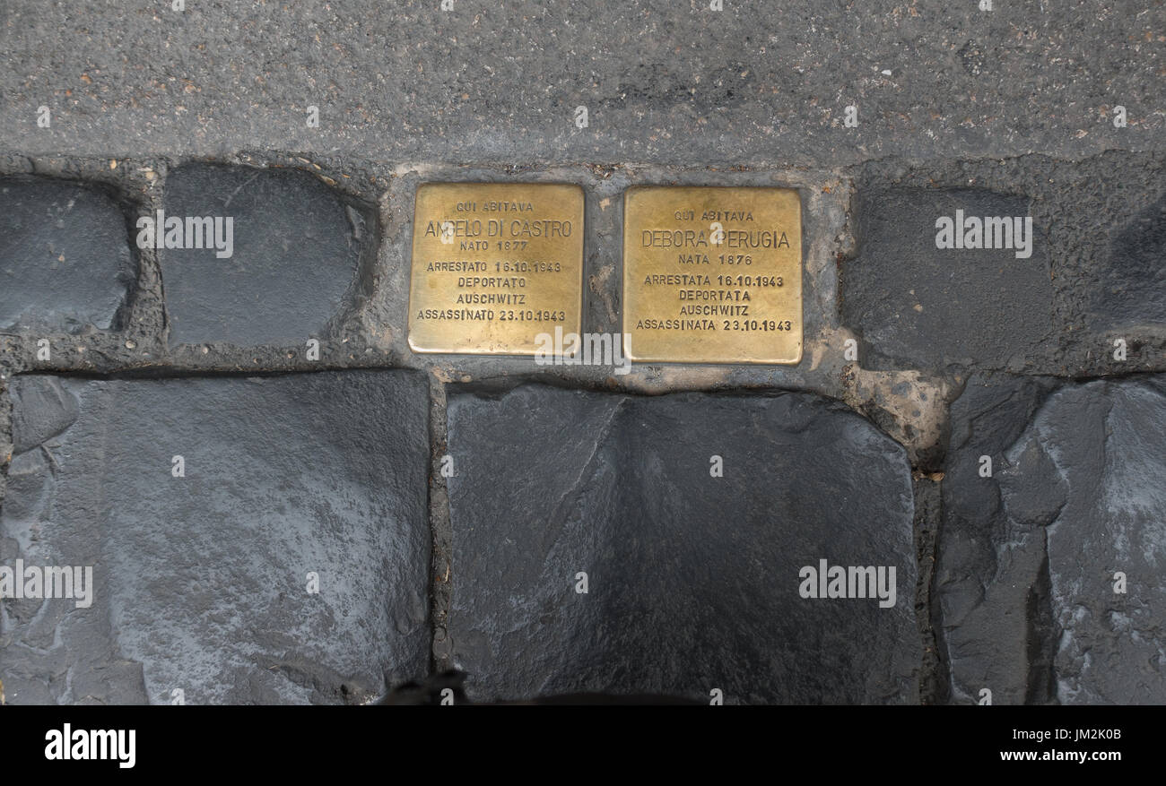 Stolpersteine aka stumbling stones at Holocaust victims' house, Rome.  Inscribed with names & dates of residents deported to Auschwitz in WW II. Stock Photo