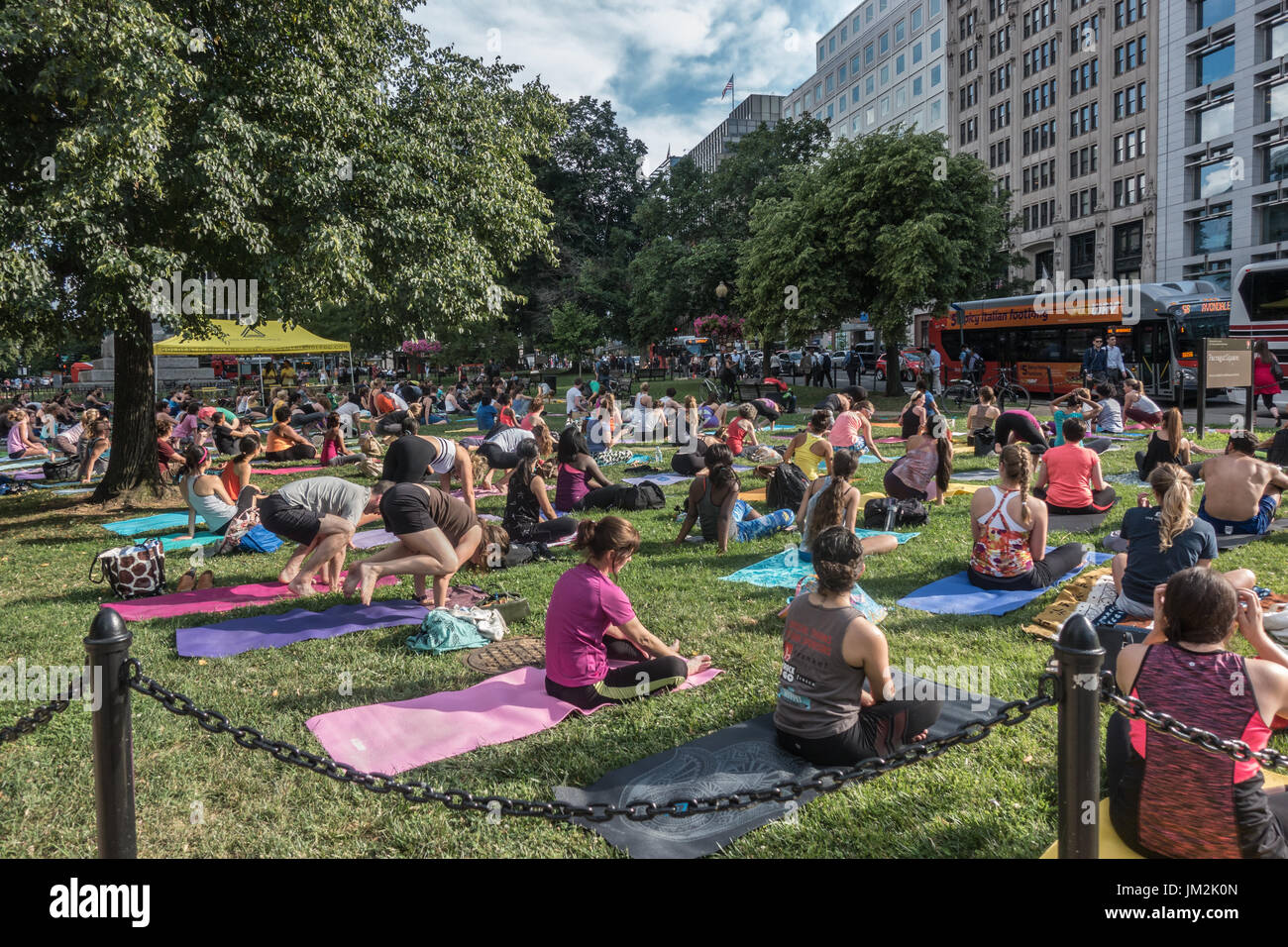 Group yoga in the park, Farragut Park, Washington, DC. Weekly early evening May - Sept. while commuters hurry home. Sponsored by Golden Triangle Assoc Stock Photo