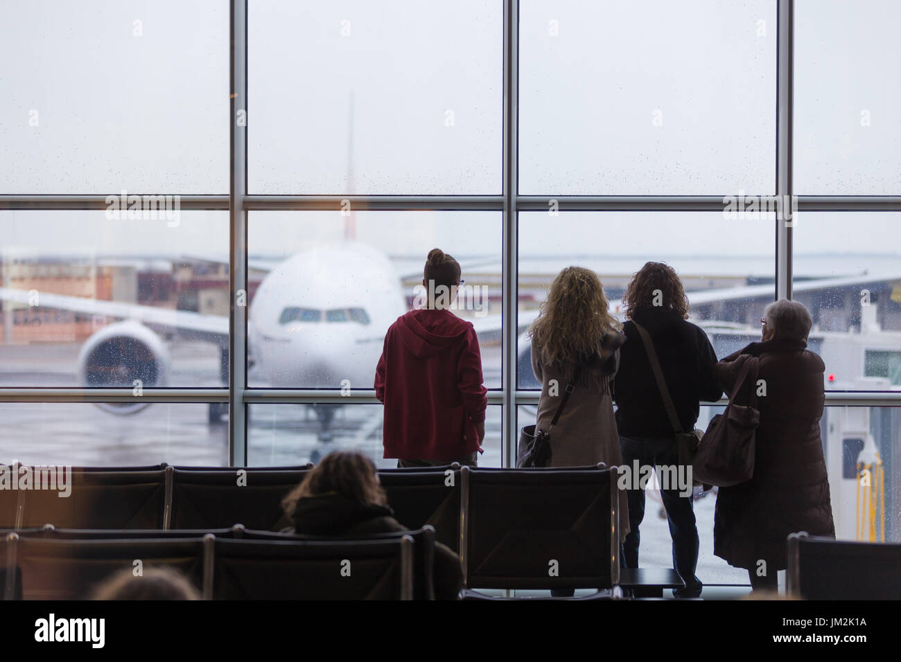 People waiting for airplane departure on a rainy day. Stock Photo