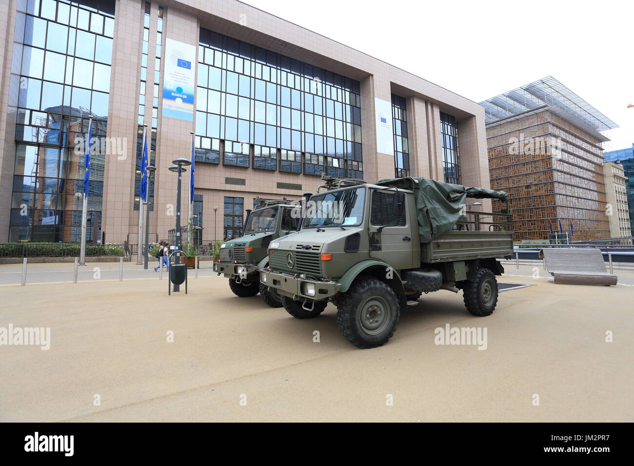 Brussels, Belgium - July 17, 2017: Military trucks opposite European Council building. Army on the streets of Brussels after the terrorist acts. Stock Photo
