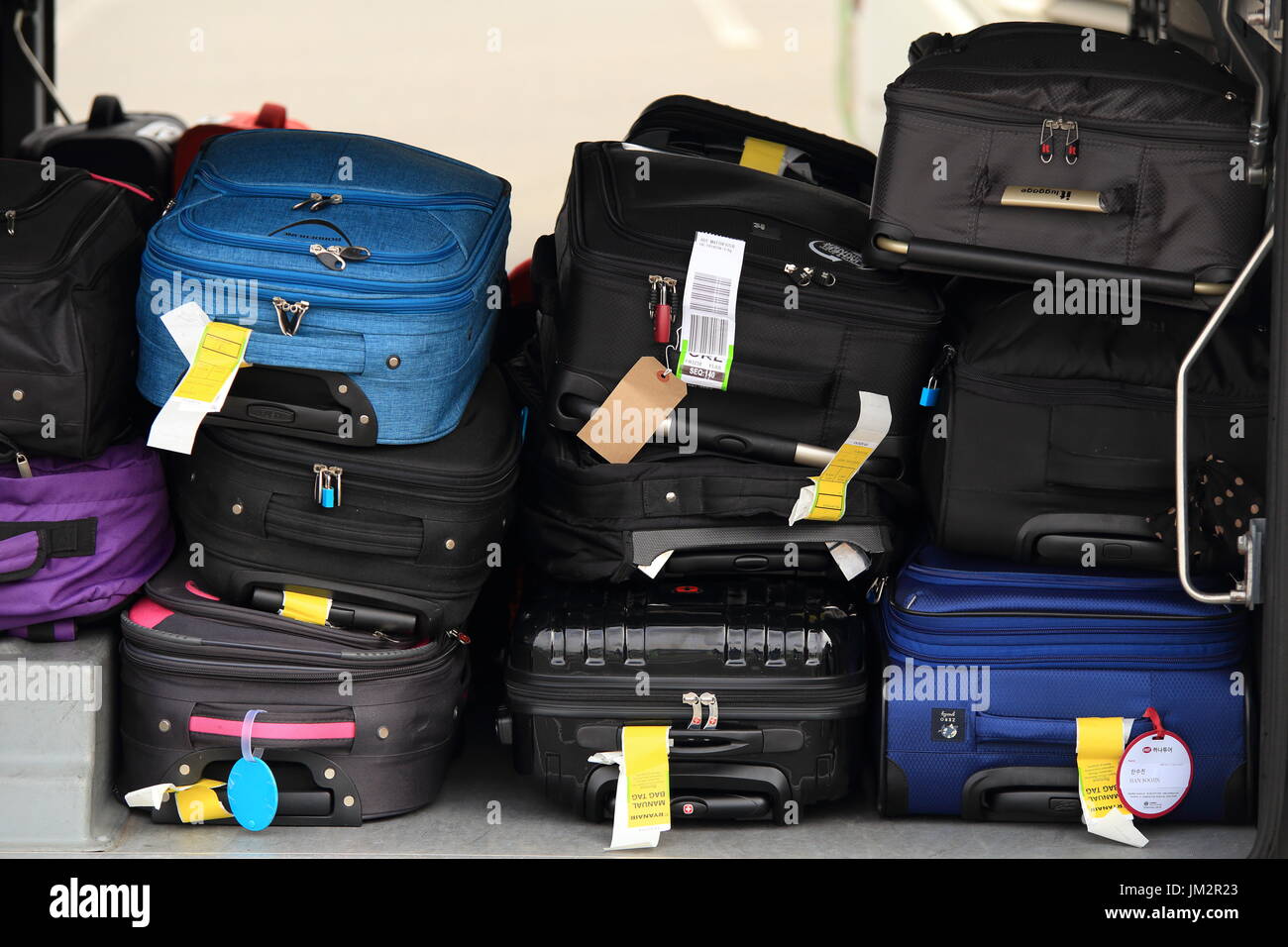 Copenhagen airport, Denmark - July 15, 2017: Passenger luggage in airplane. Colorful suitcases in airplane close-up. Stock Photo