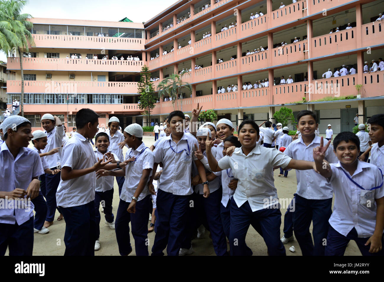 Bangladeshi school students walking on the school ground at class break ...