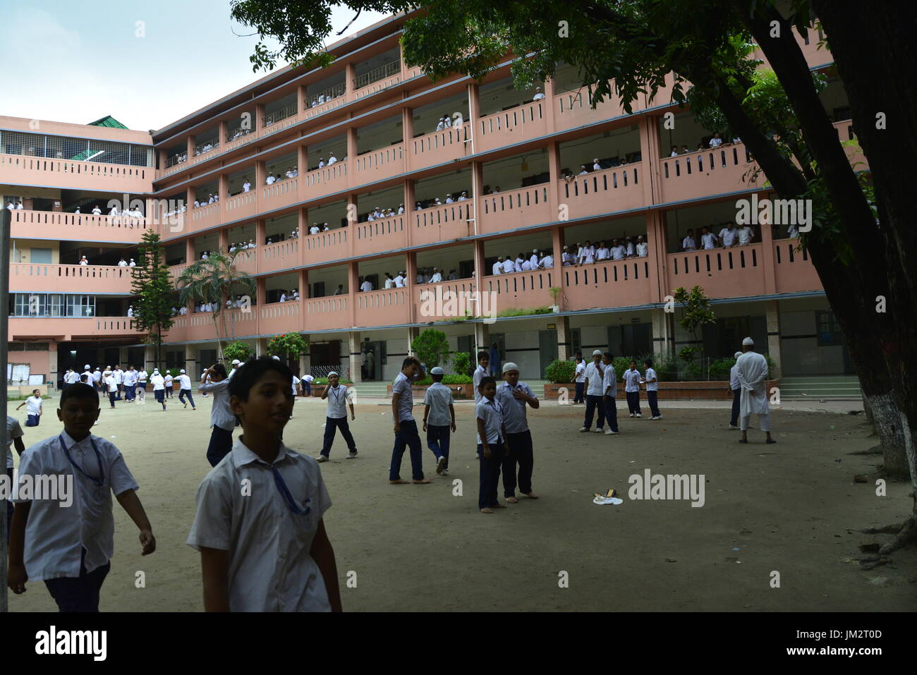 Bangladeshi school students walking on the school ground at class break ...