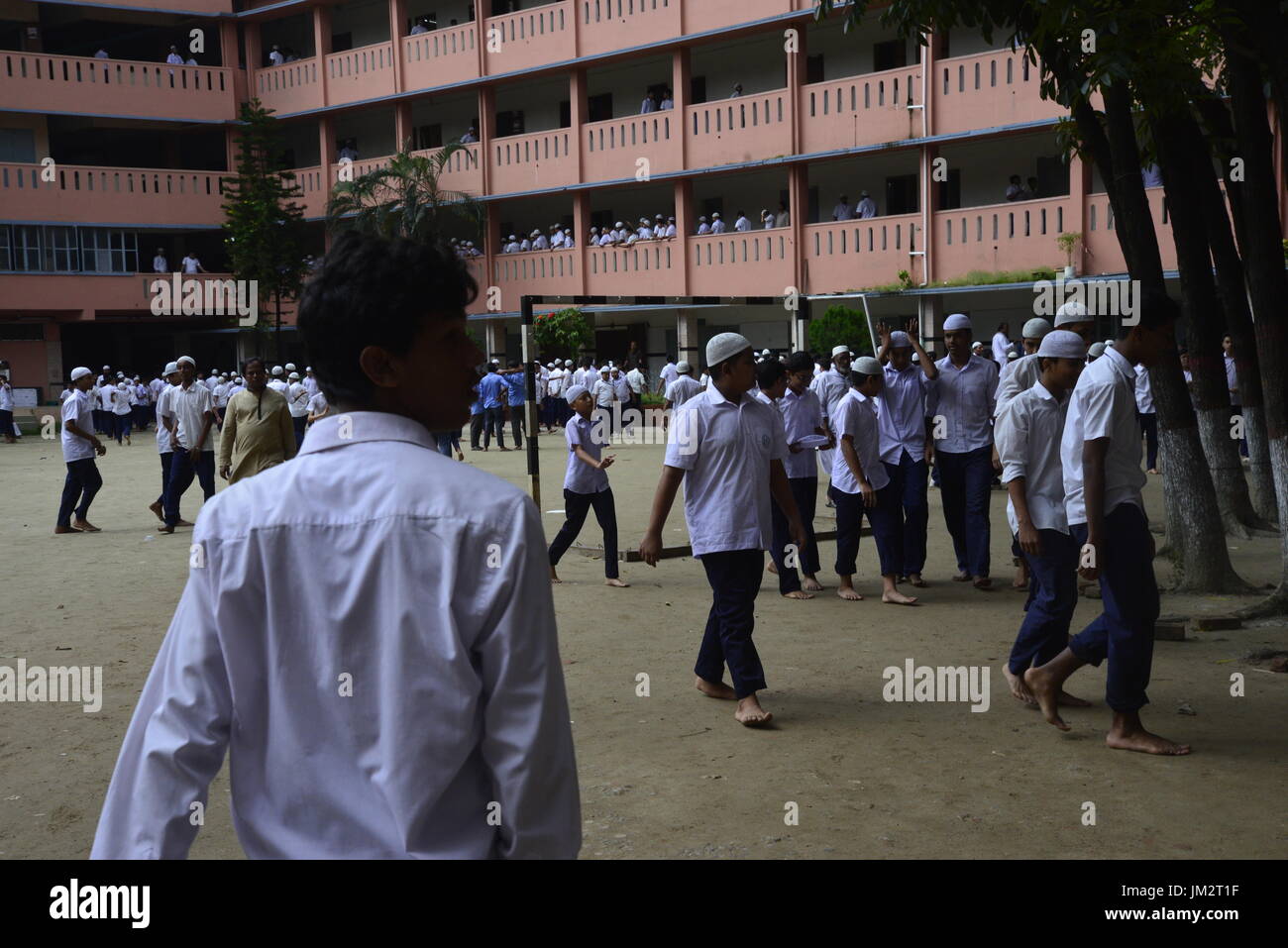 Bangladeshi school students walking on the school ground at class break ...