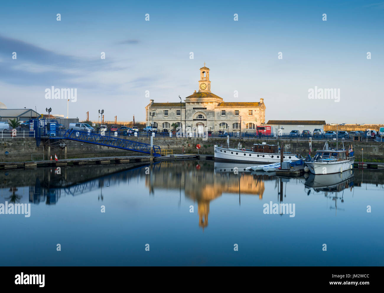 Ramsgate Maritime Museum reflected in the Royal Marina at sunset. Stock Photo