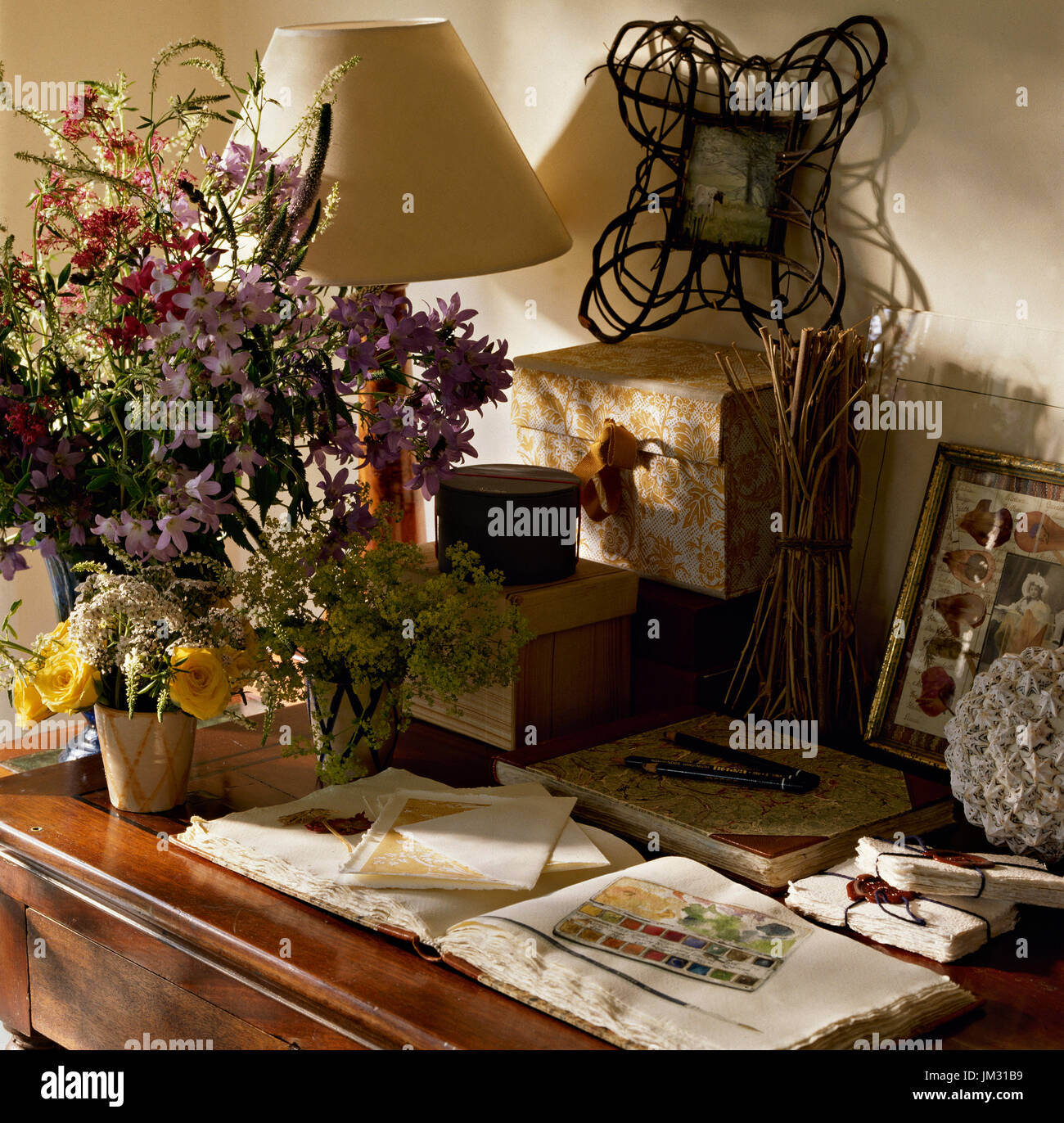 Flower arrangements and art equipment on table Stock Photo Alamy