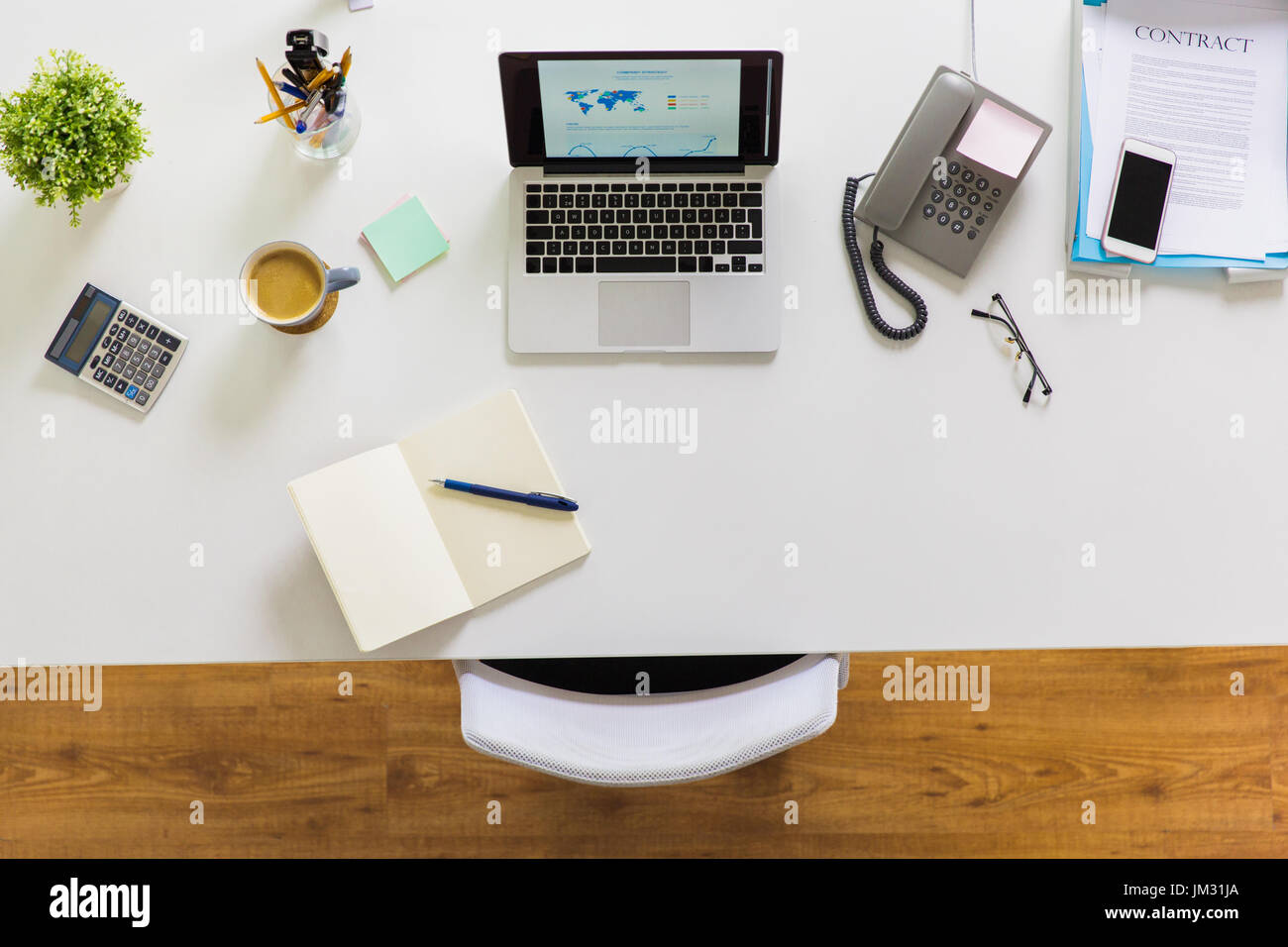 laptop, phone and other office stuff on table Stock Photo