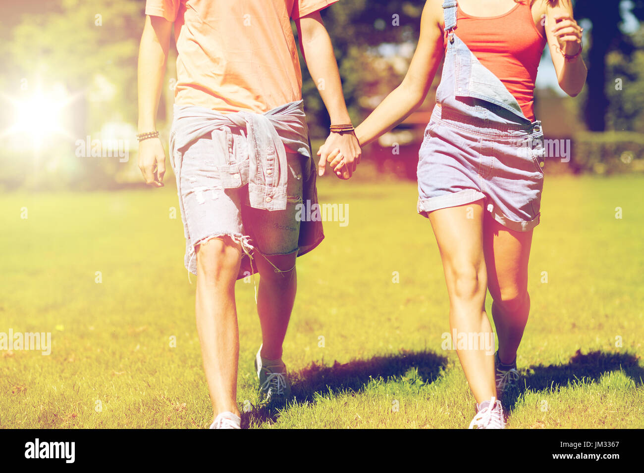 Teen couple walking holding hands hi-res stock photography and images ...