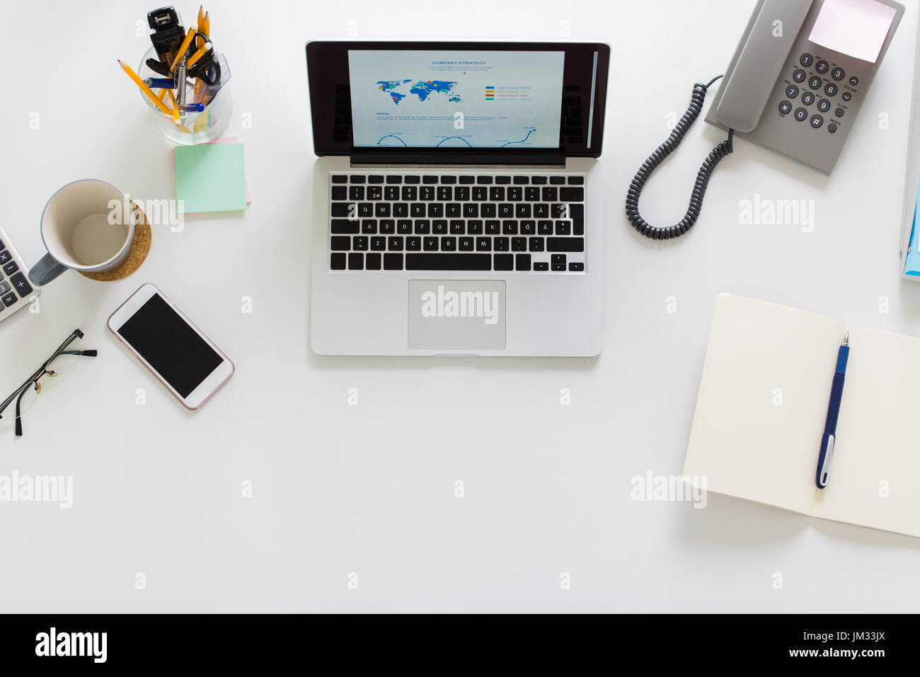 laptop, phone and other office stuff on table Stock Photo