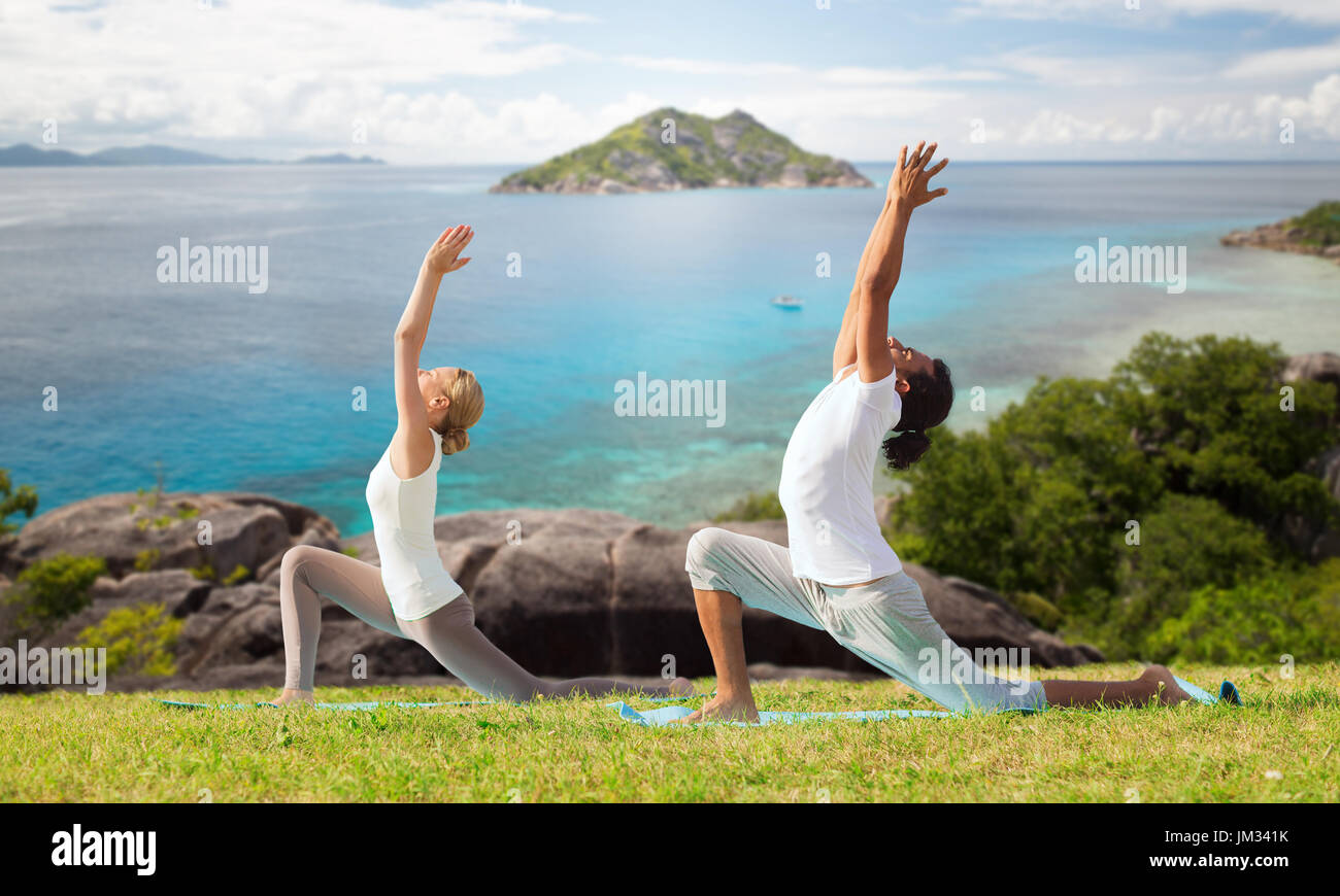 couple making yoga in low lunge pose outdoors Stock Photo - Alamy