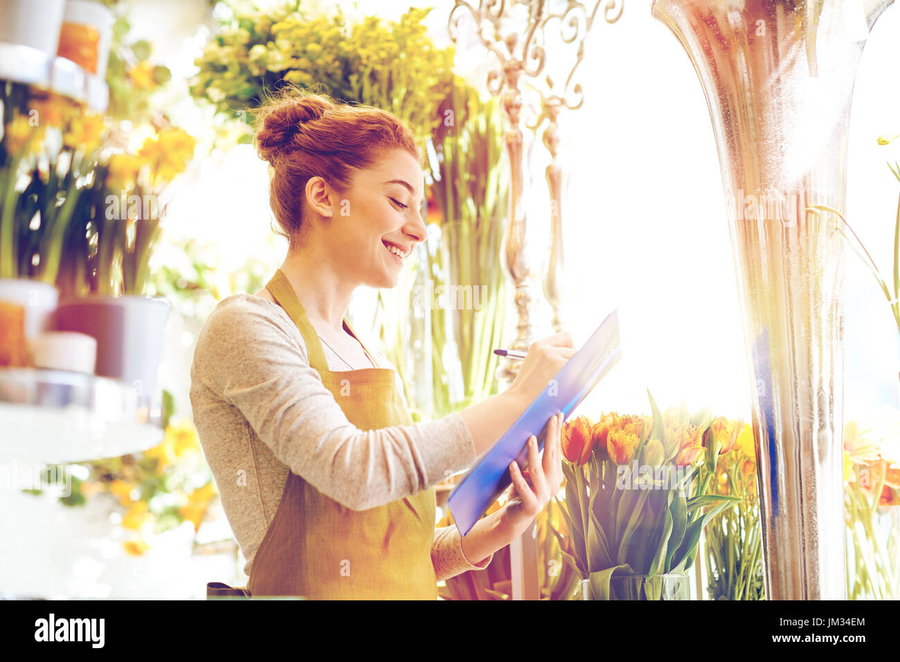 florist woman with clipboard at flower shop Stock Photo - Alamy