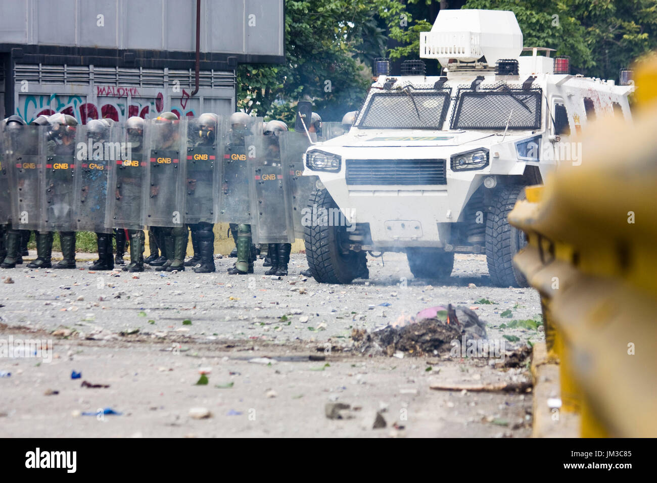 The Bolivarian National Guard confront demonstrators that were blocking a street as a protest against the government of Nicolás Maduro. Stock Photo