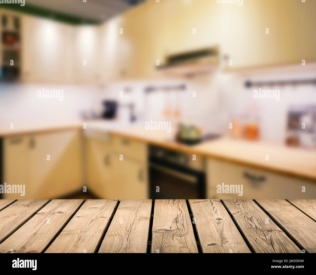 wooden counter top with kitchen blurred background Stock Photo