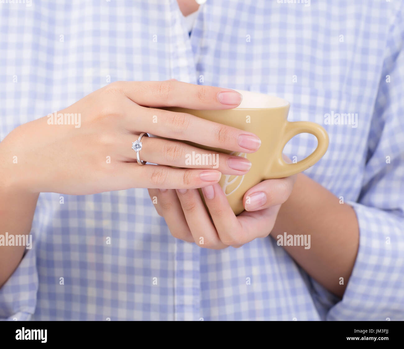female hands holding a cup of coffee Stock Photo