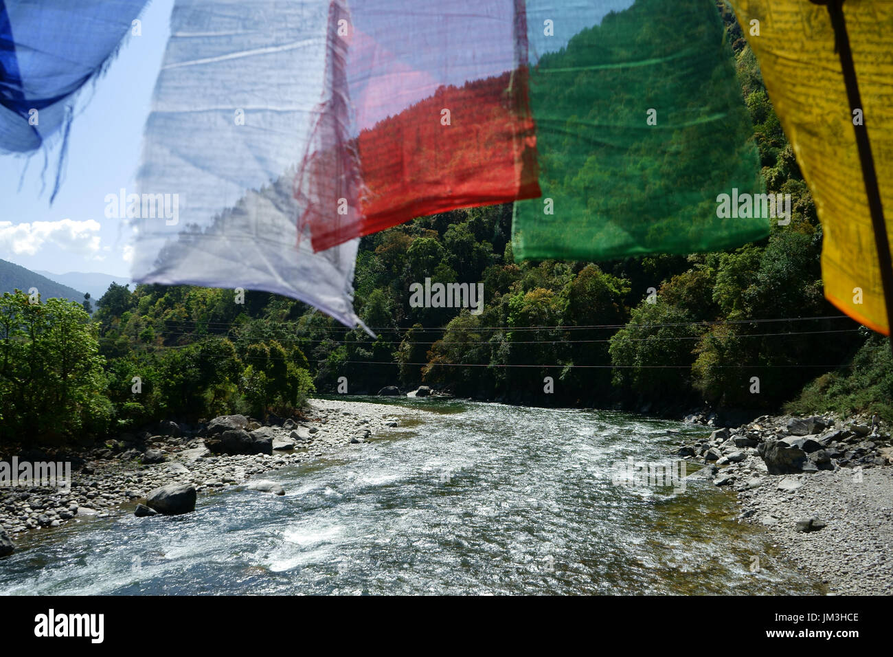 Prayer flags above Punakha river seen from suspension bridge, Bhutan Stock Photo
