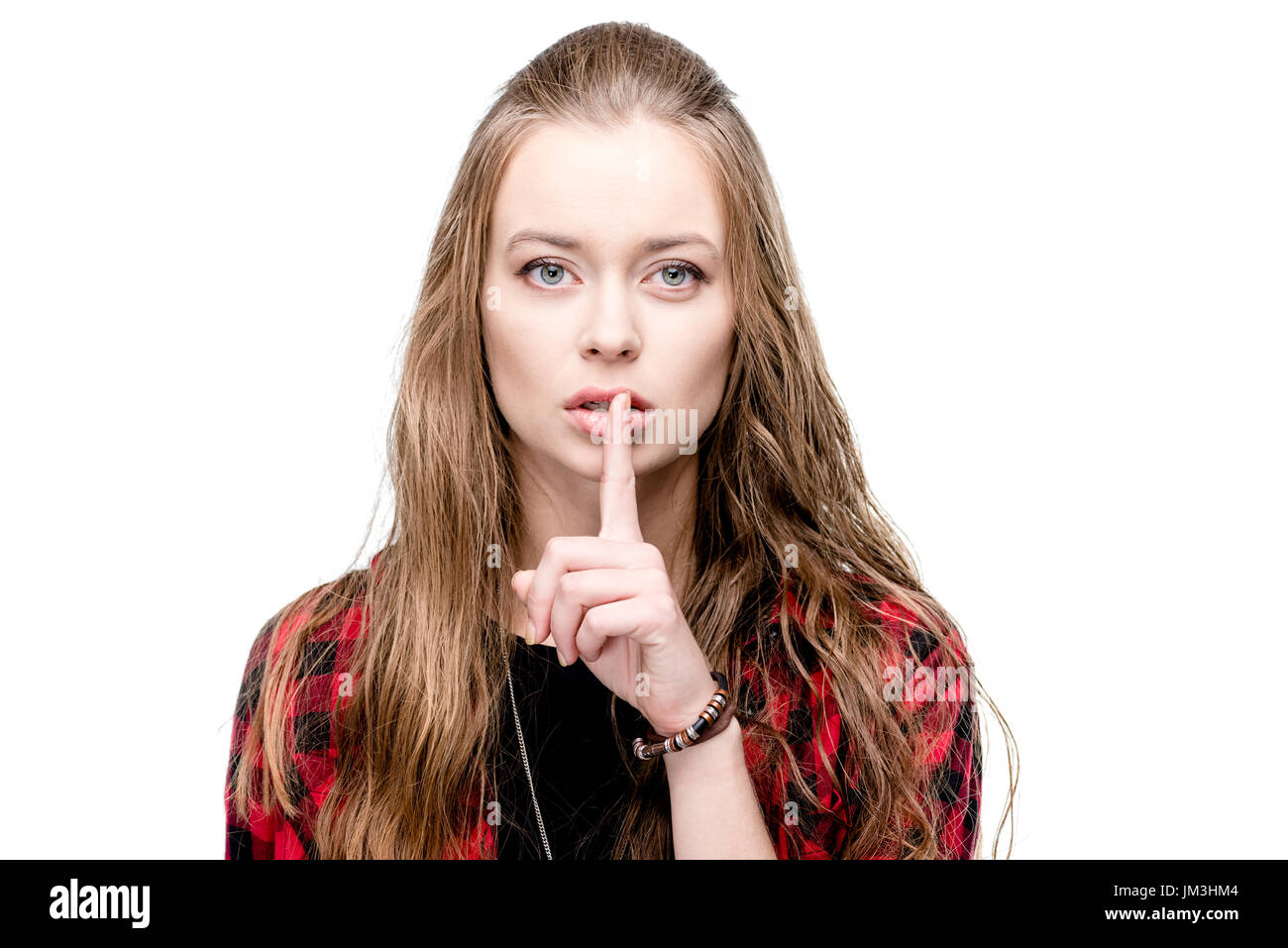 portrait of young attractive woman with silence gesture looking at camera isolated on white Stock Photo