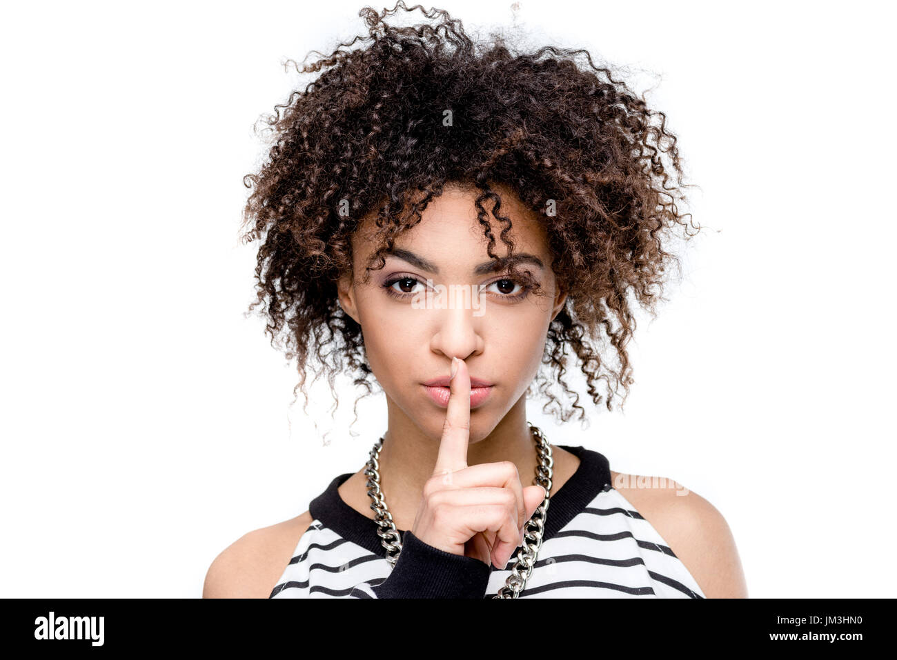 young african american woman with silence gesture looking at camera isolated on white Stock Photo