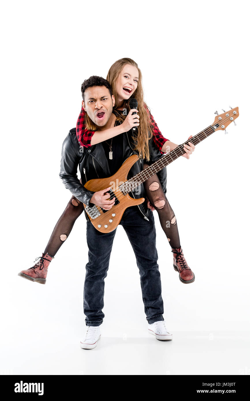 Happy young couple of musicians with microphone and electric guitar performing music together isolated on white Stock Photo
