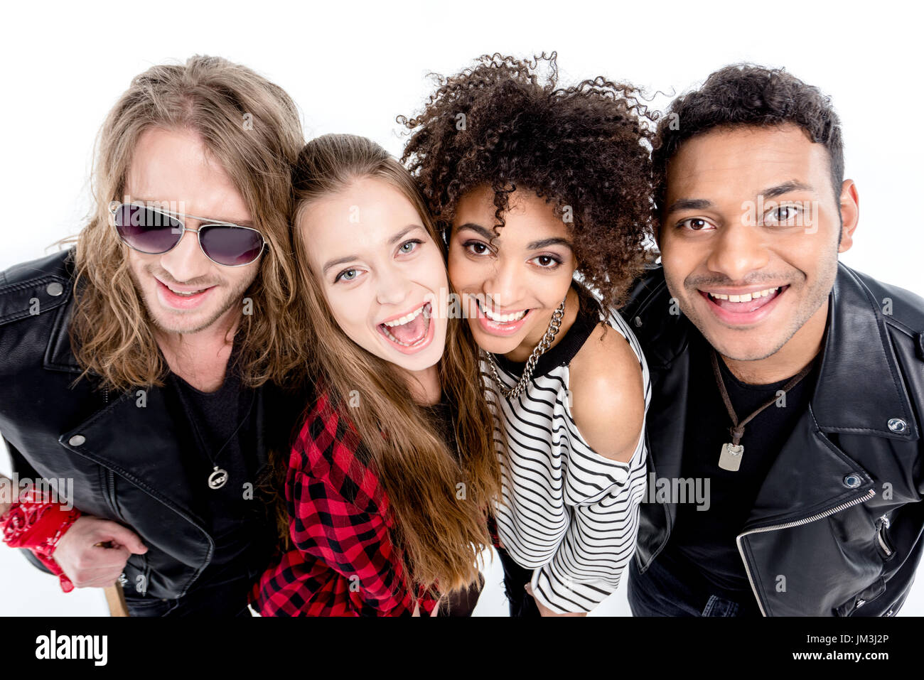 Close-up portrait of happy young rock and roll band smiling at camera Stock Photo