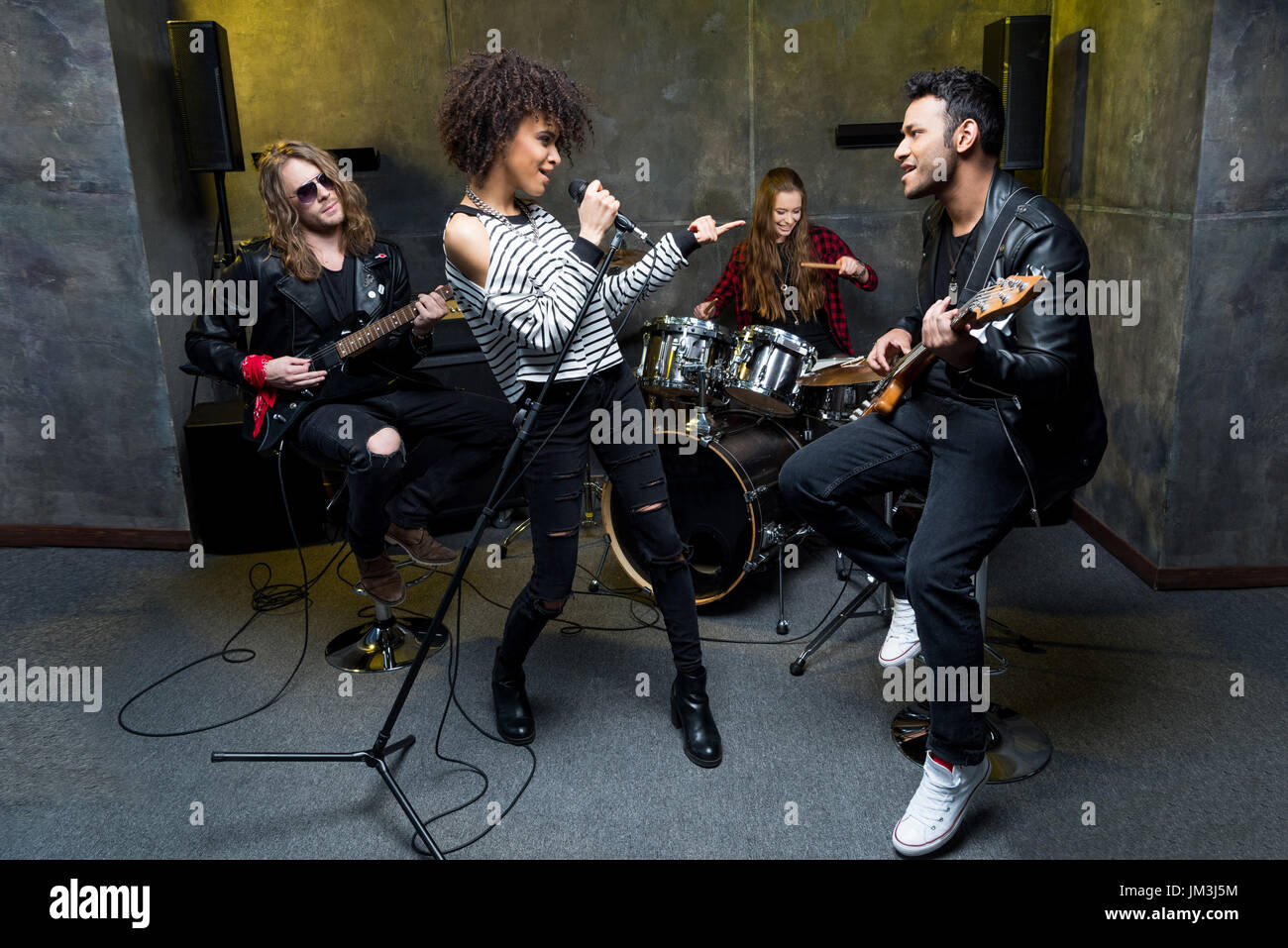 Young multiethnic rock and roll band rehearsing in musical studio Stock  Photo - Alamy