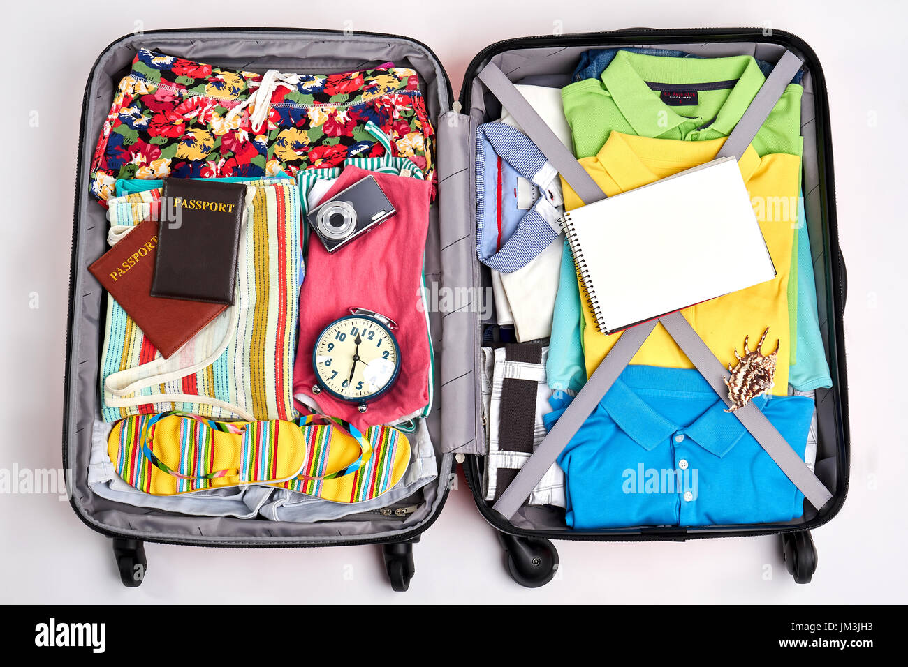 Ready suitcase for travelling. Opened suitcase full of clothing. Stock Photo