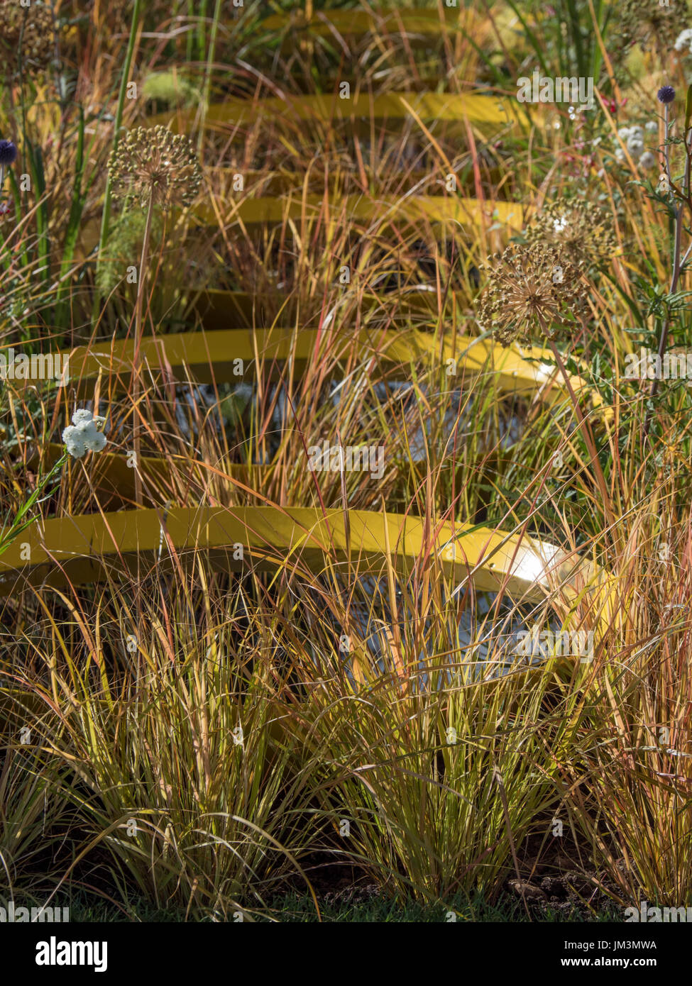 Kinetica show garden.  Gold water pans planted in grass   Designer John Warland’s. Stock Photo