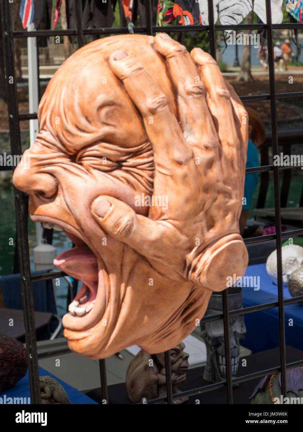 Novelty ornamental screaming head on display in market. Stock Photo