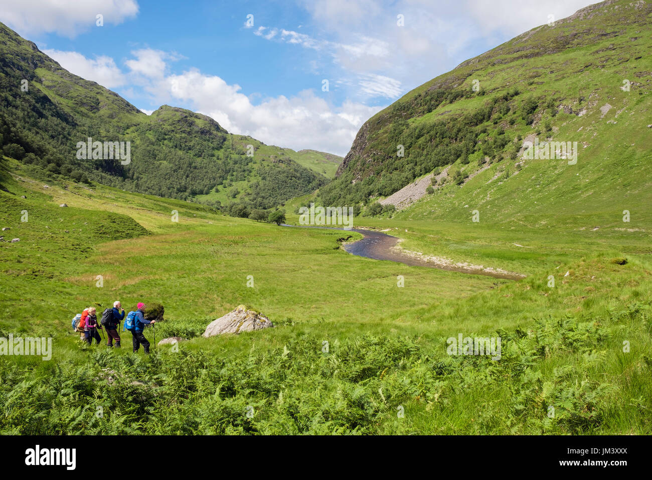 Glen Nevis valley with hikers hiking below The Mamores mountains. Fort William Inverness-shire Highland Scotland UK Britain Stock Photo