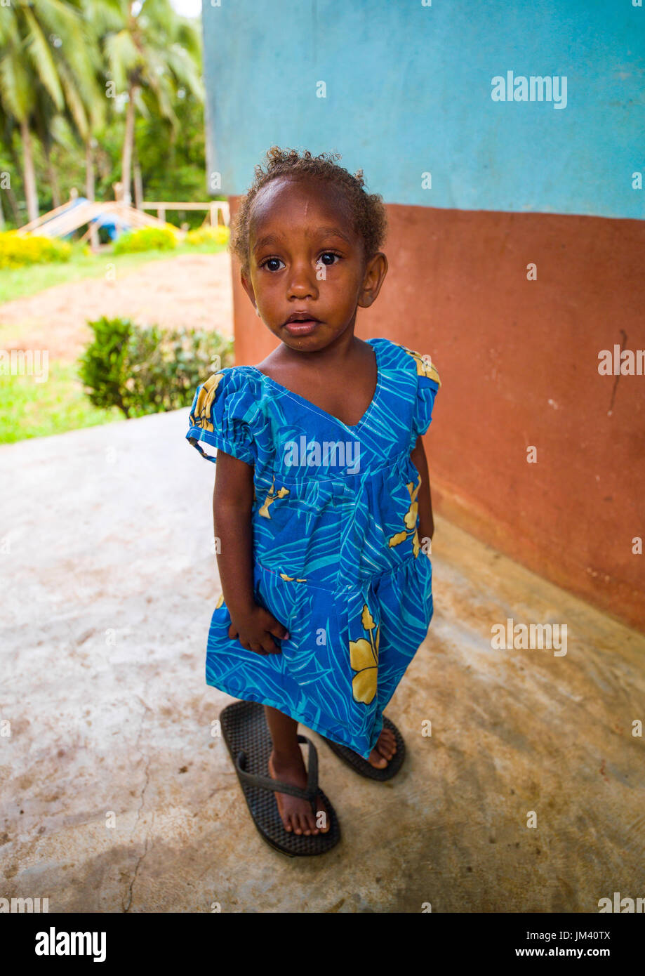 Portrait of a Ni-Vanuatu girl walking with shoes too big for her, Malampa Province, Malekula Island, Vanuatu Stock Photo