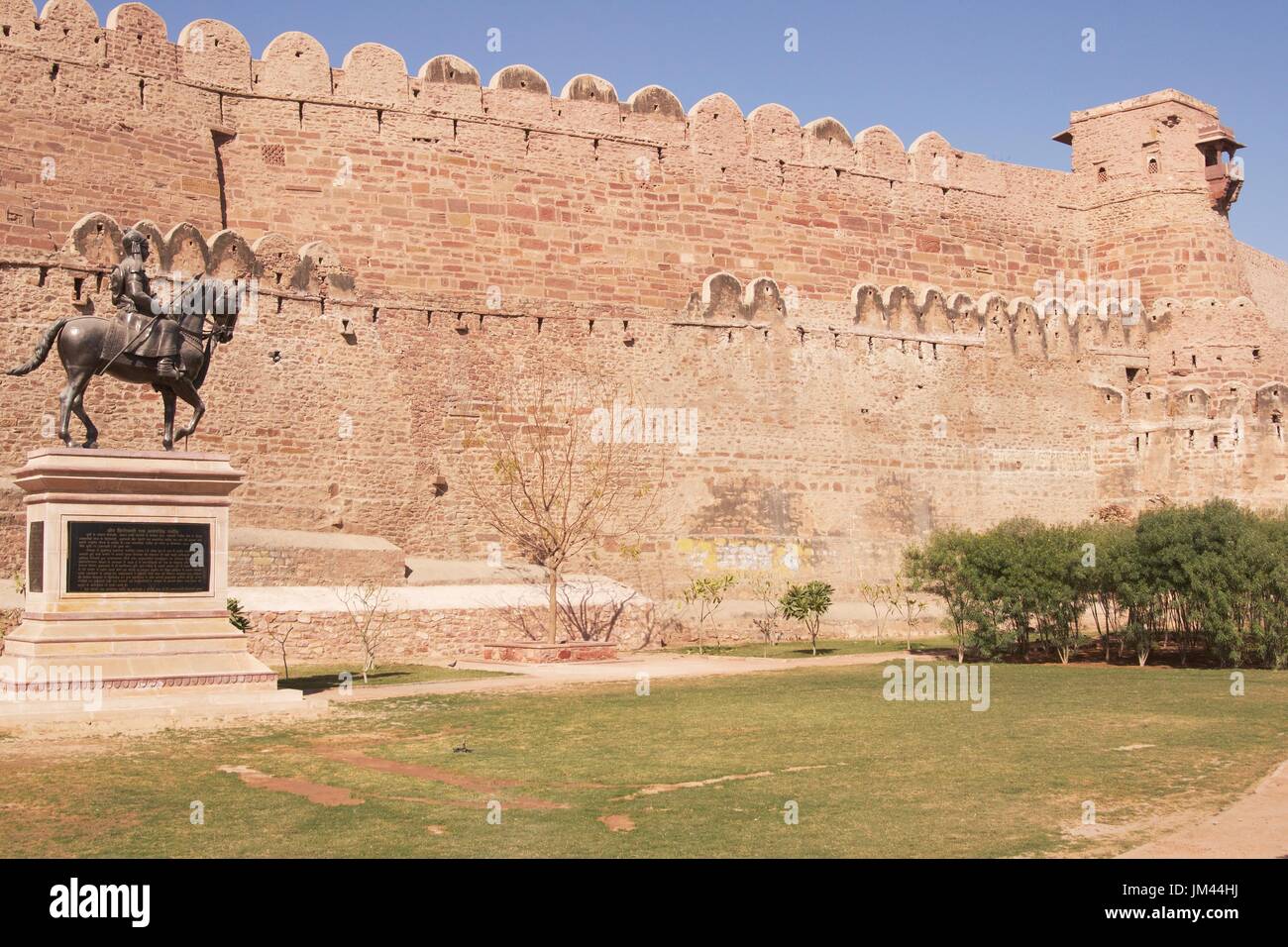 Ancient Indian fortress at Nagaur, Rajasthan, India. Large fortified perimeter wall. Statue in garden. Stock Photo