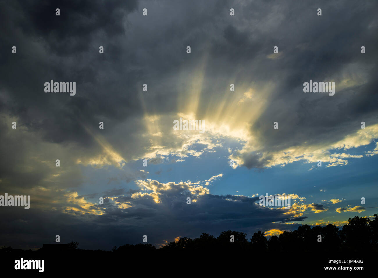 Clouds With Sun Rays Shining Through After A Late Afternoon Rain Storm Stock Photo Alamy