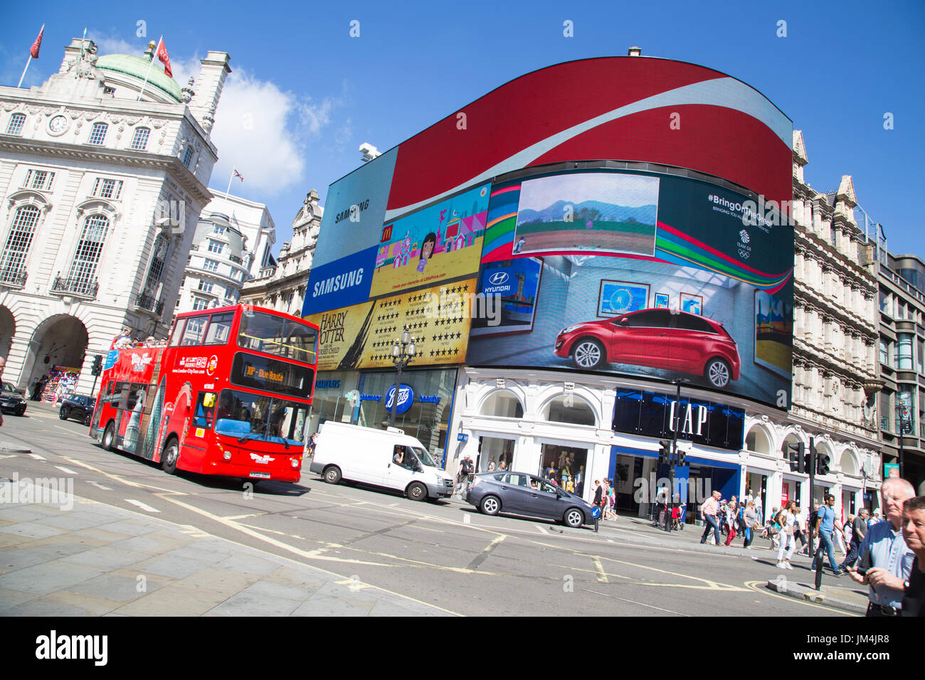 LONDON, UK - AUG 12, 2016. site seeing bus passes large screen in piccadilly circus Stock Photo