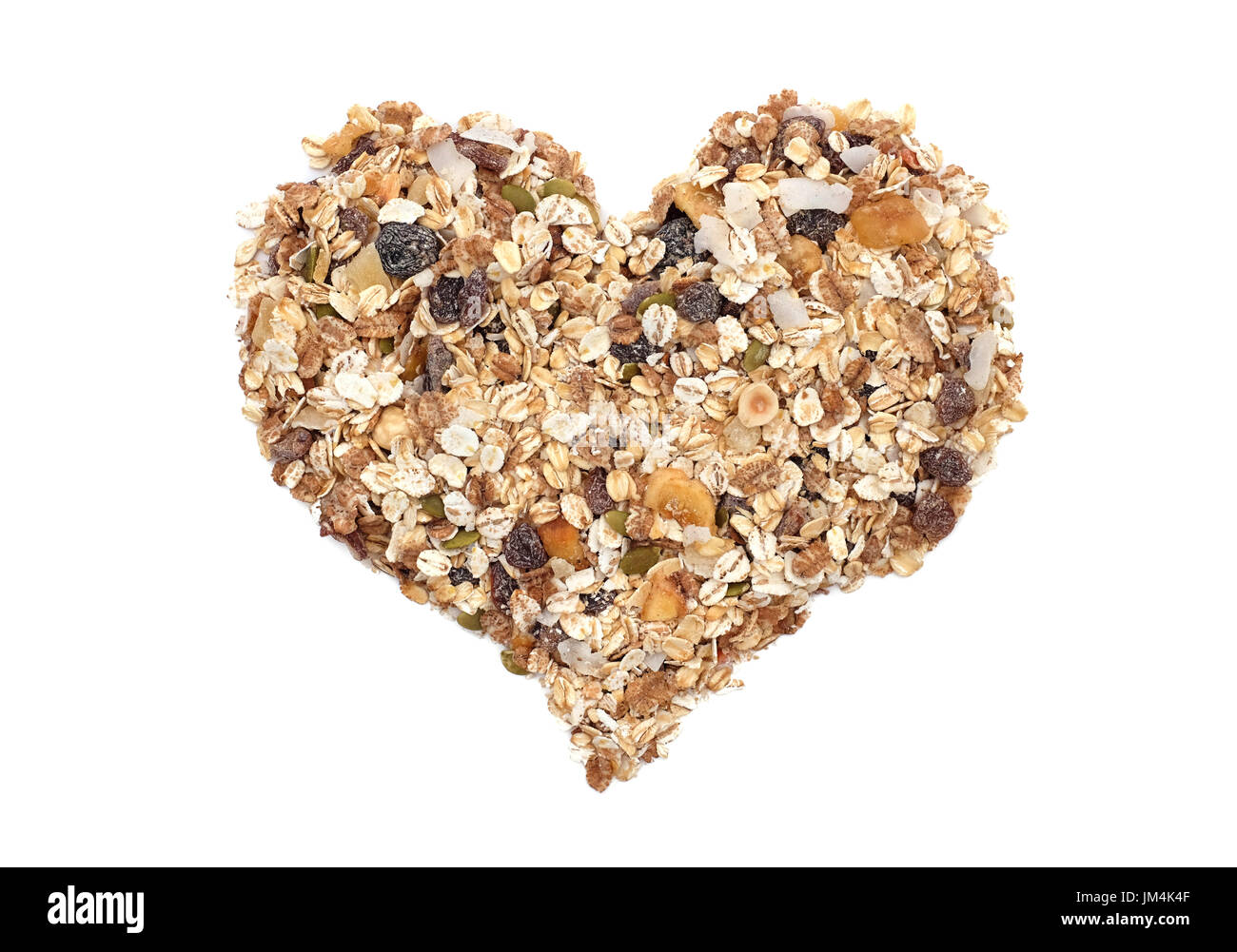 Muesli cereal grains, seeds, fruit and nuts in a heart shape, isolated