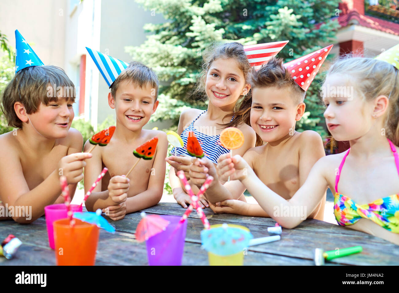 Birthday. Happy children in hats with candy.  Stock Photo