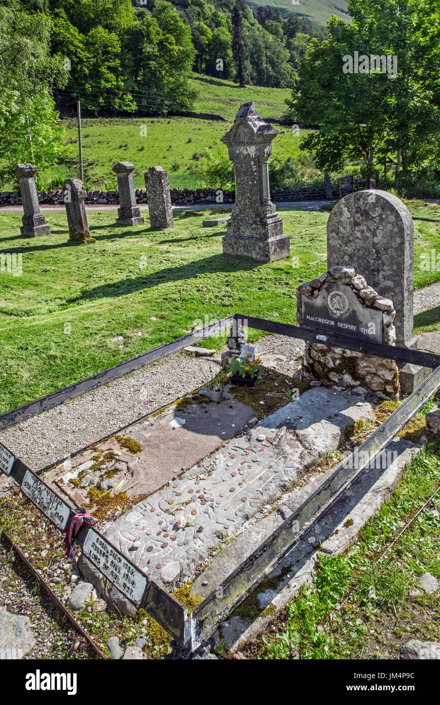 Coins on the graves of Rob Roy MacGregor, his wife Mary and his two sons Coll and Robin at the Balquhidder kirkyard, Stirling, Scotland, UK Stock Photo