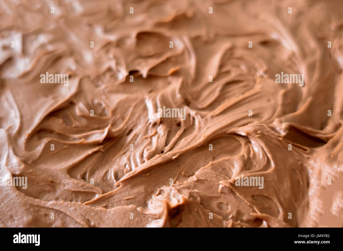 Chocolate cake frosting with swirls Stock Photo - Alamy