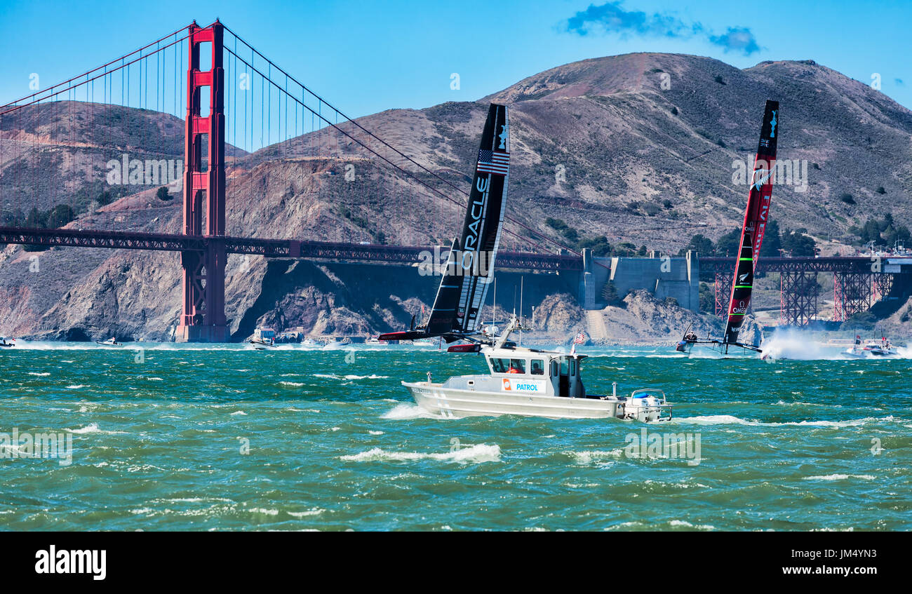 SAN FRANCISCO, SEPT 25, 2013: Oracle Team USA and Team New Zealand approach the Golden Gate Bridge during the final race of America's Cup. USA won Stock Photo