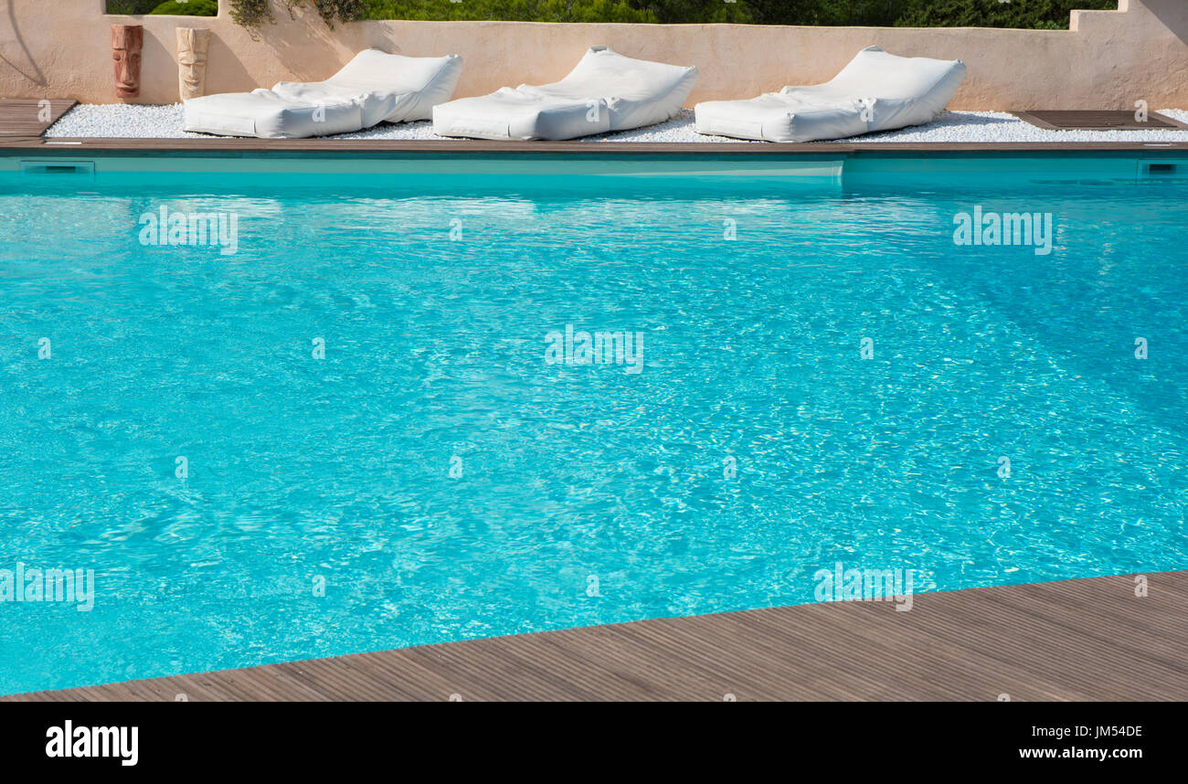 comfortable mattresses to rest in the pool with turquoise water Stock Photo