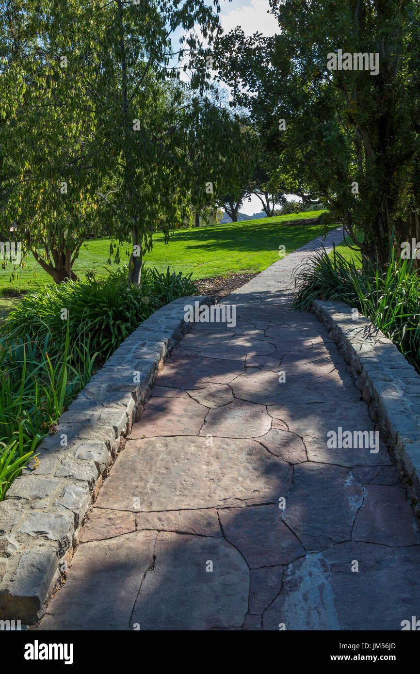 stone bridge, flagstone walkway, landscaped garden, Far Niente Winery, Oakville, Napa Valley, Napa County, California Stock Photo
