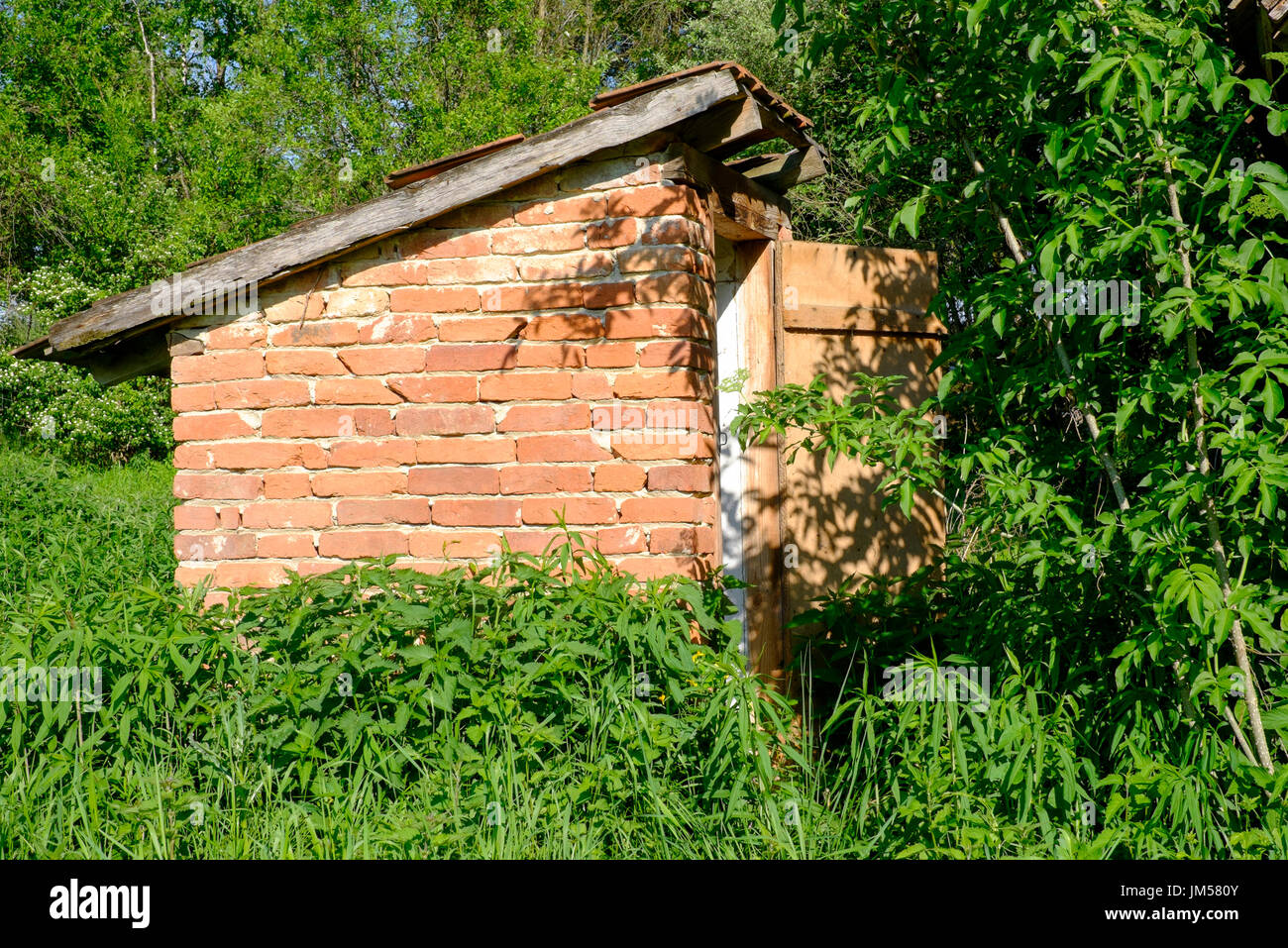 outside toilet outbuilding in the garden of a typical rural village house in zala county hungary Stock Photo