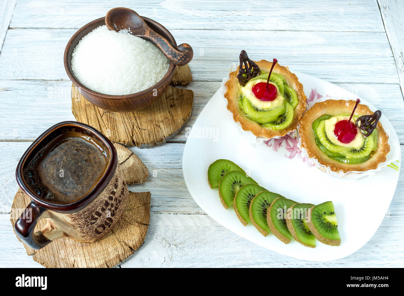 Dish shaped like a smile. Smile from fruits. Dessert in the form of a little man. Coffee and cake. Stock Photo