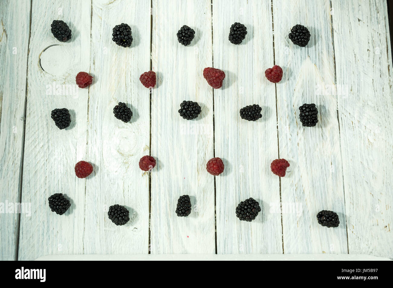 Blackberry and raspberries. are arranged in a row. Flat lay. Berries on