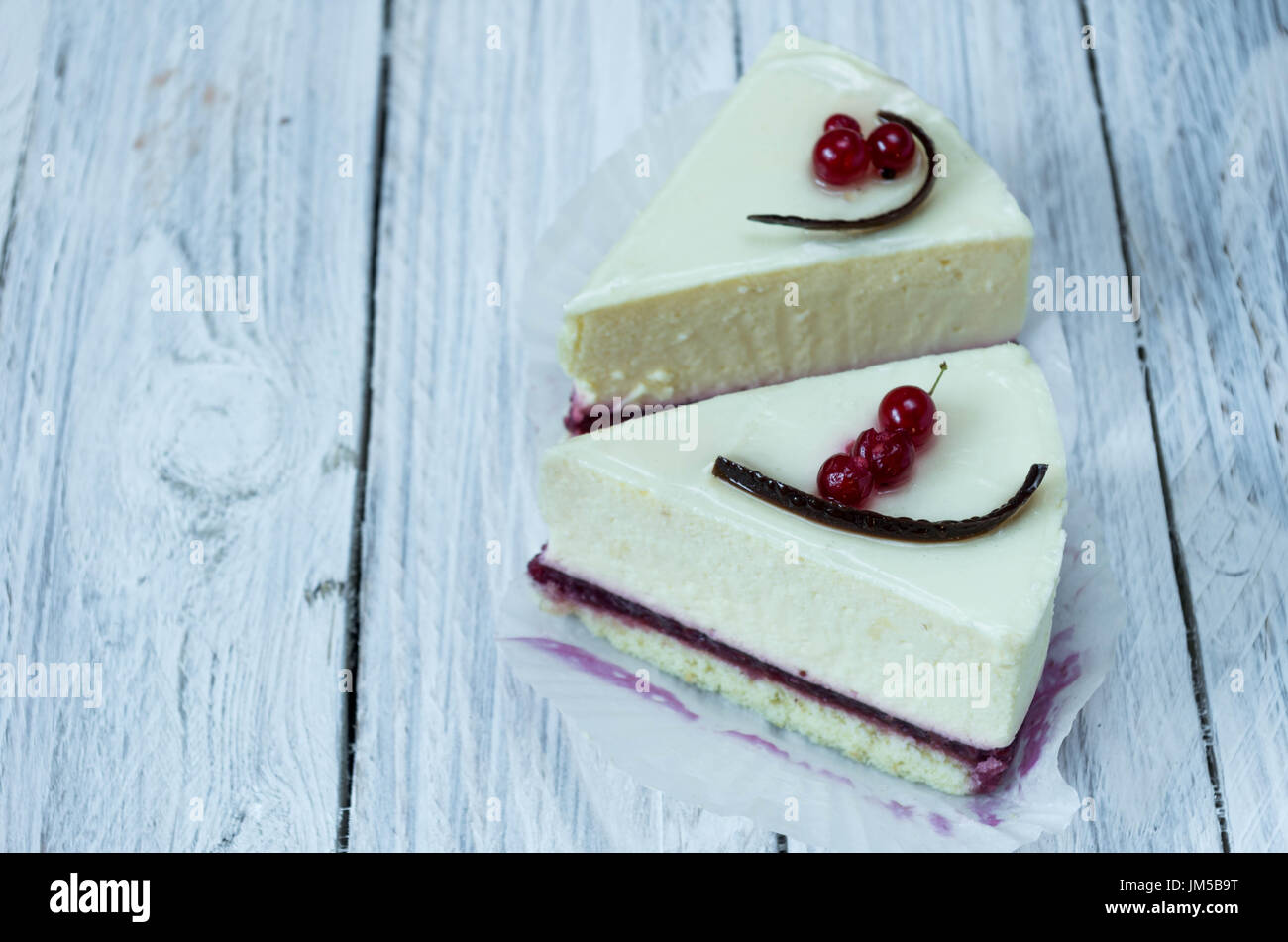 Two white cheesecakes on a white background. Dessert menu. Stock Photo