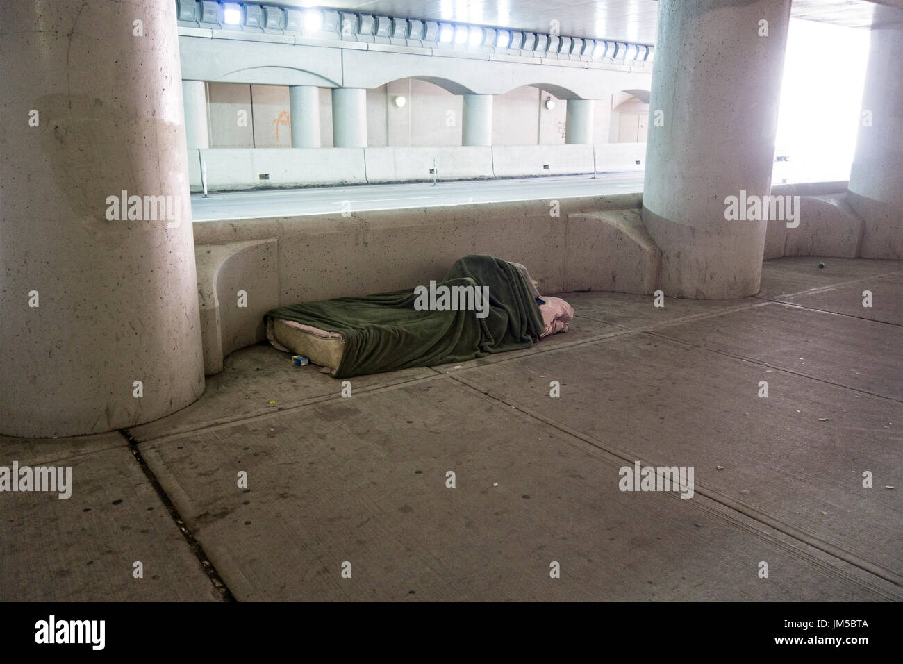 Unoccupied bed for homeless person along Lower Simcoe Street in downtown Toronto Ontario Canada Stock Photo