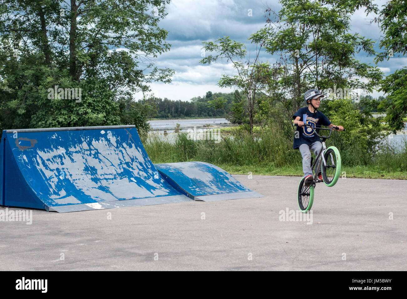 Teenage boy popping a wheelie on bicycle during BMX competition at Omemee Days Stock Photo