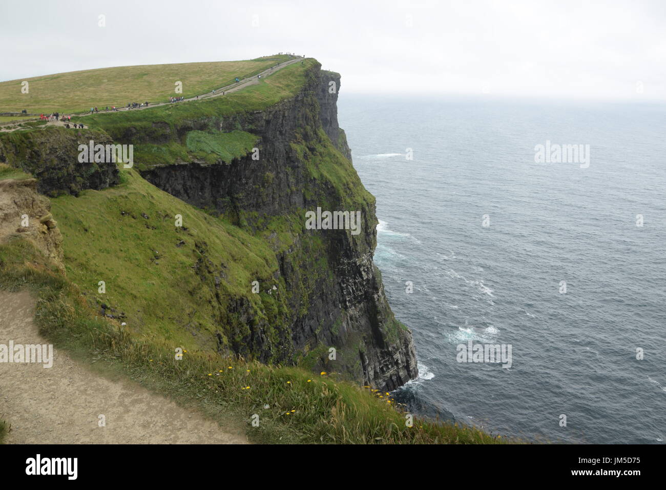 View of the Cliffs of Moher and tourist path in the County Clare, west Ireland Stock Photo